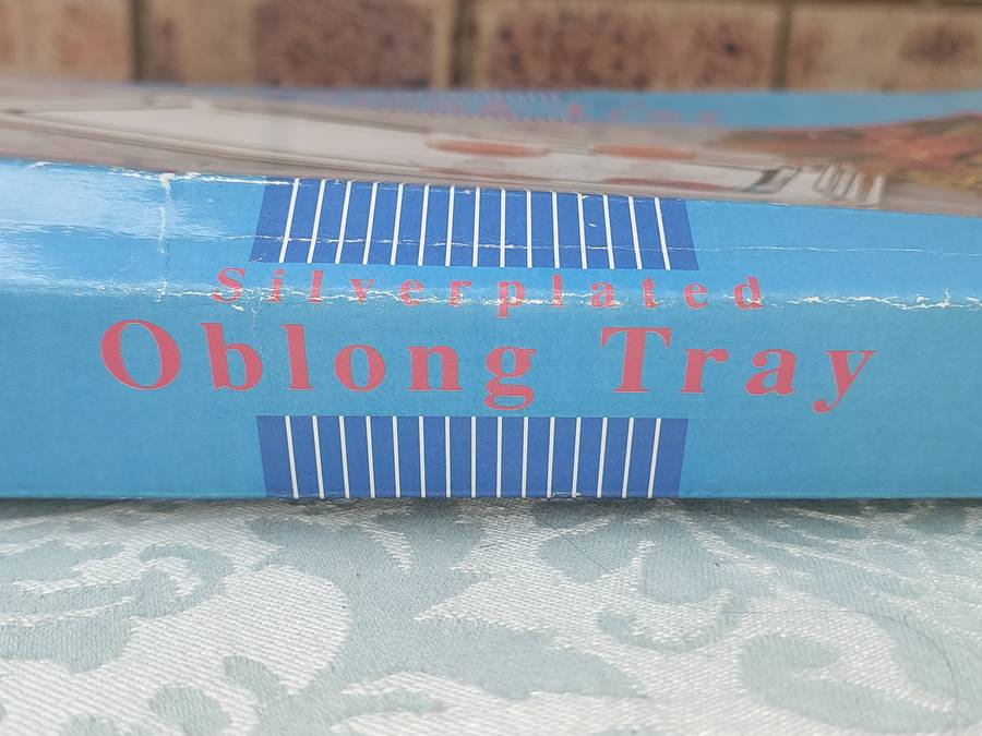 A SILVER PLATED OBLONG SERVING TRAY SOLD AS IS