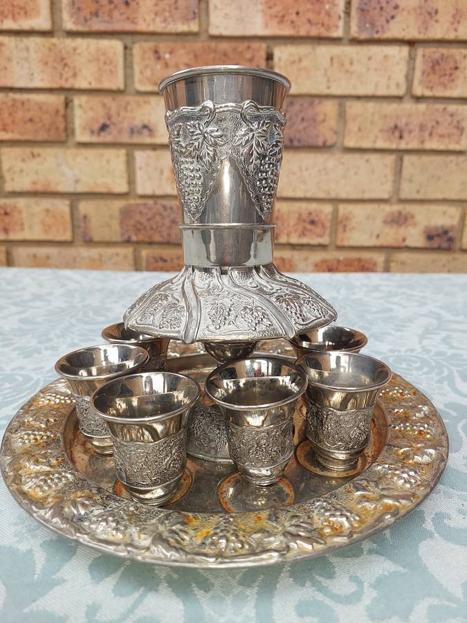 A VINTAGE KIDDUSH SET WITH 2 CUPS MISSING SOLD AS IS