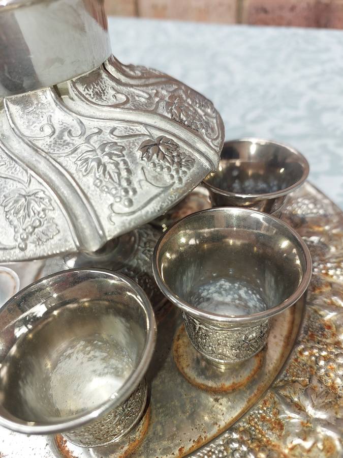 A VINTAGE KIDDUSH SET WITH 2 CUPS MISSING SOLD AS IS