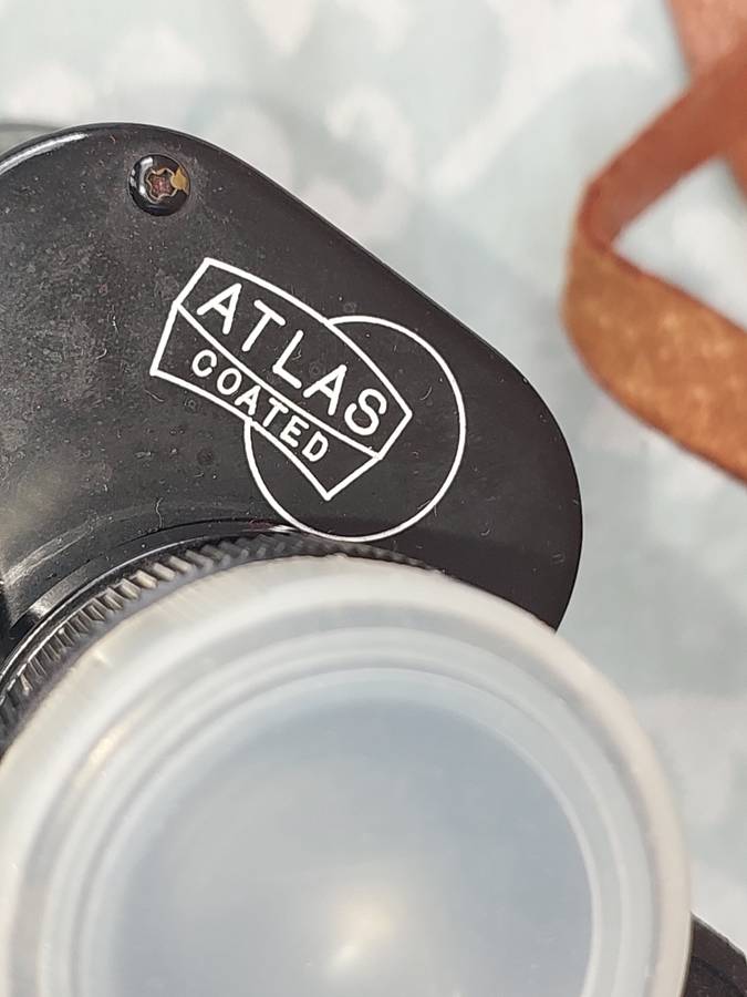 A VINTAGE ATLAS 8X30MM BINOCULARS SOLD AS IS
