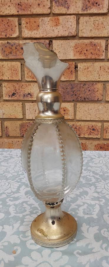 AN ORNATE ART DECOR OIL JUG SOLD AS IS