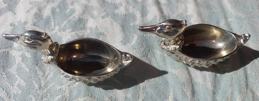 A COLLECTION OF PEWTER PHOTO FRAMES, FIGURINES  AND TWO SILVER PLATE DUCK SALTS