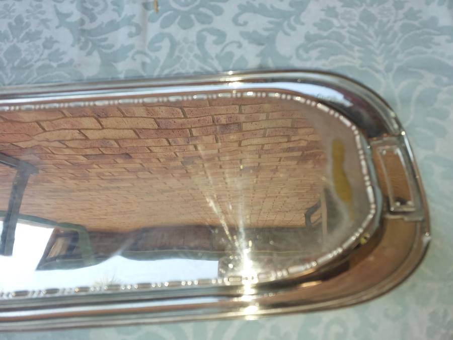 A SILVER PLATED RECTANGULAR SERVING PLATER SOLD AS IS