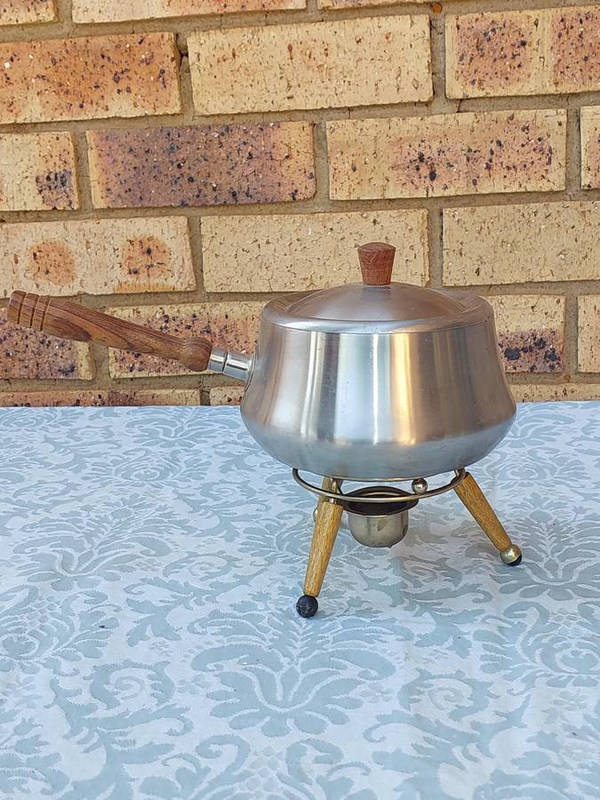 A VINTAGE SAUCE PAN WITH WOODEN HANDLE AND WARMER STAND
