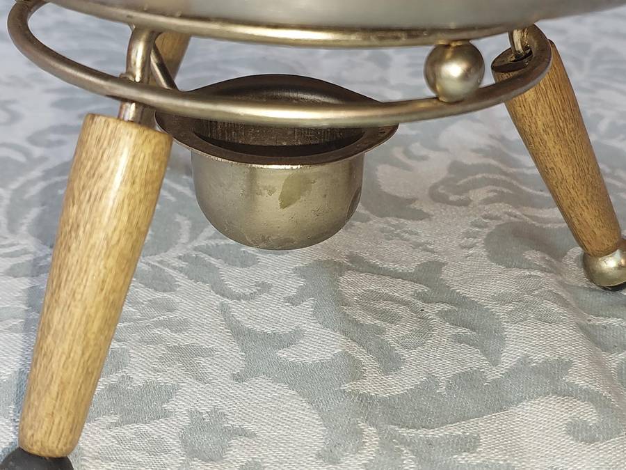 A VINTAGE SAUCE PAN WITH WOODEN HANDLE AND WARMER STAND