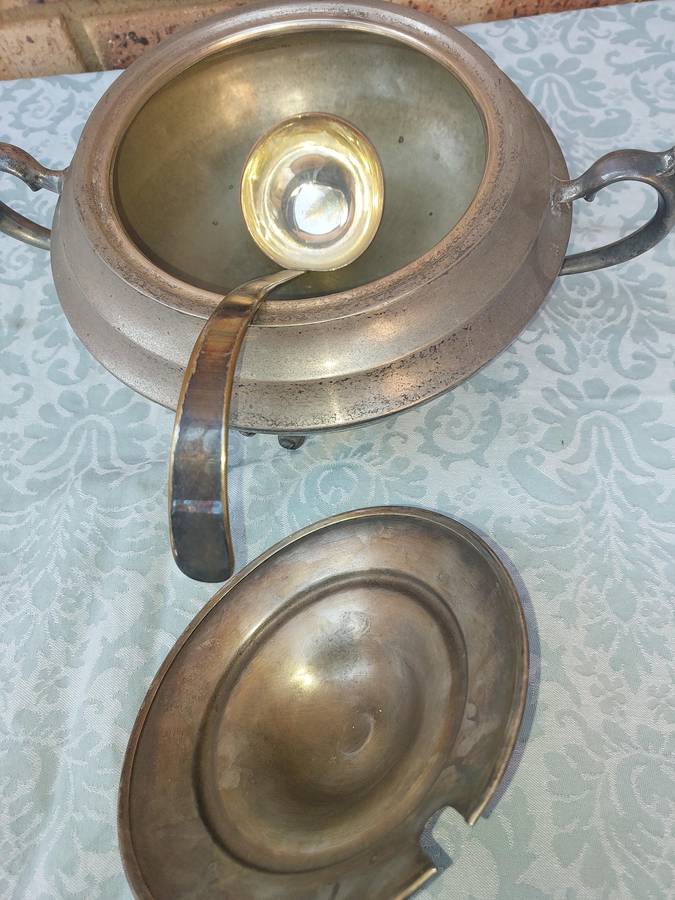 AN ANTIQUE SILVER PLATED TUREEN WITH A LADLE SOLD AS IS