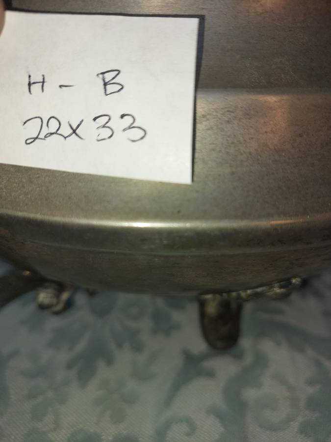 AN ANTIQUE SILVER PLATED TUREEN WITH A LADLE SOLD AS IS