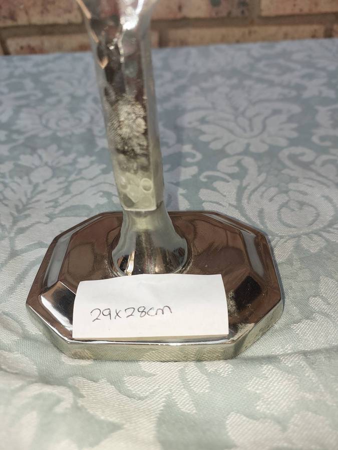 A BEAUTIFULL CHROME PLATED MINORA WITH LAQUERED CANDLE HOLDERS SOLD AS IS
