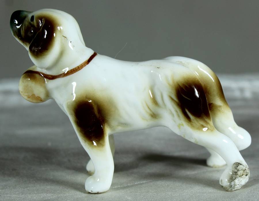 Miniature porcelain dog with barrel