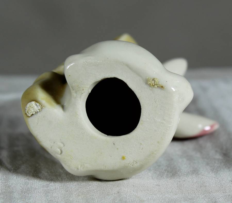 Miniature glazed ceramic bunny playing a bass