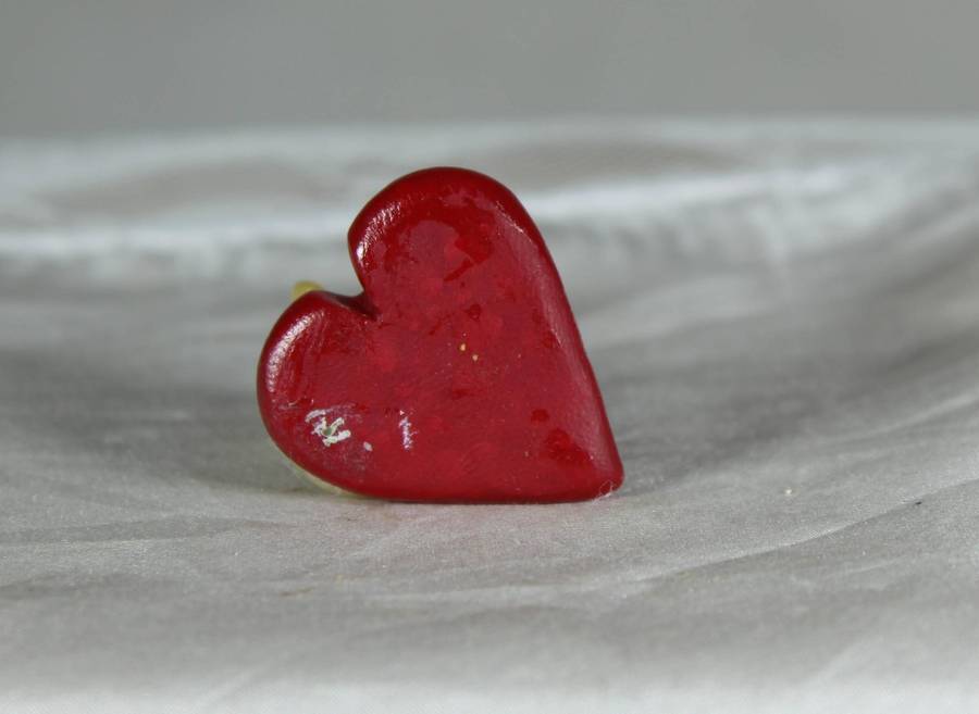 Mini miniature tooth mouse on a heart
