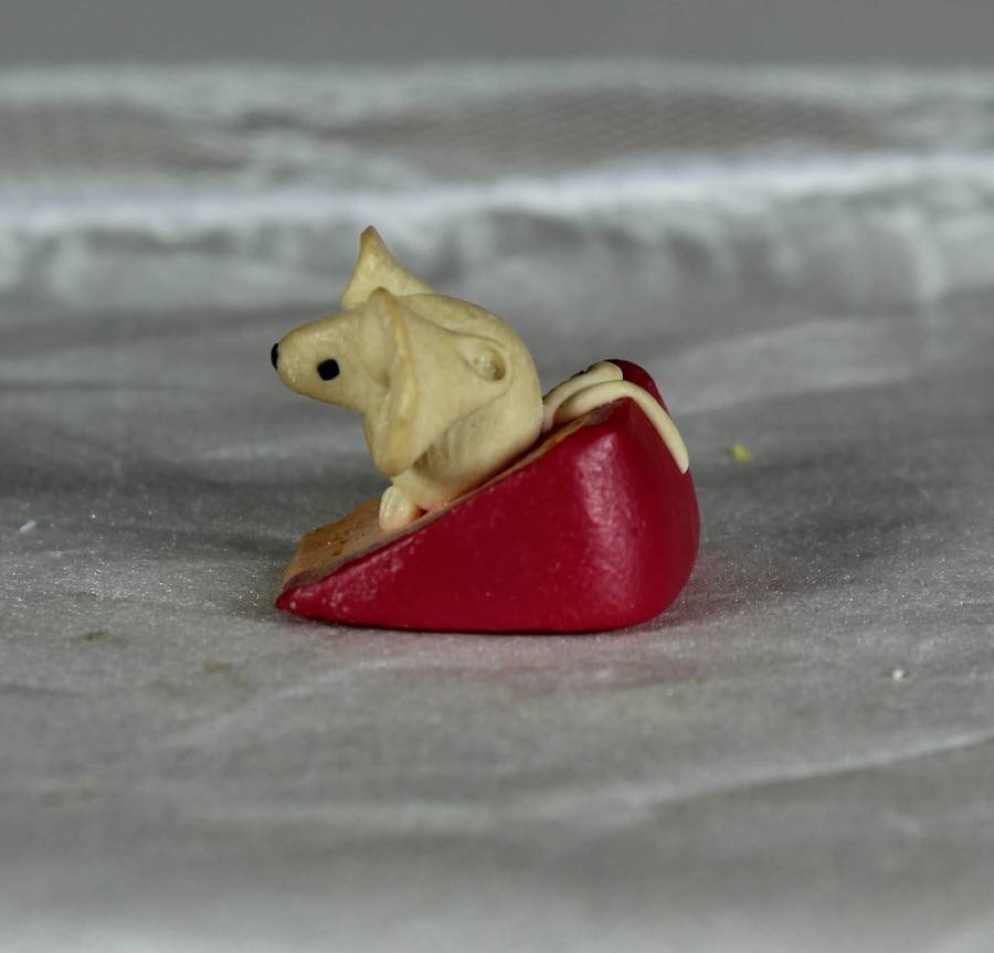 Mini miniature mouse on a slice of cheese