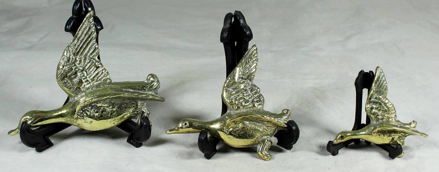 Trio of flying brass geese