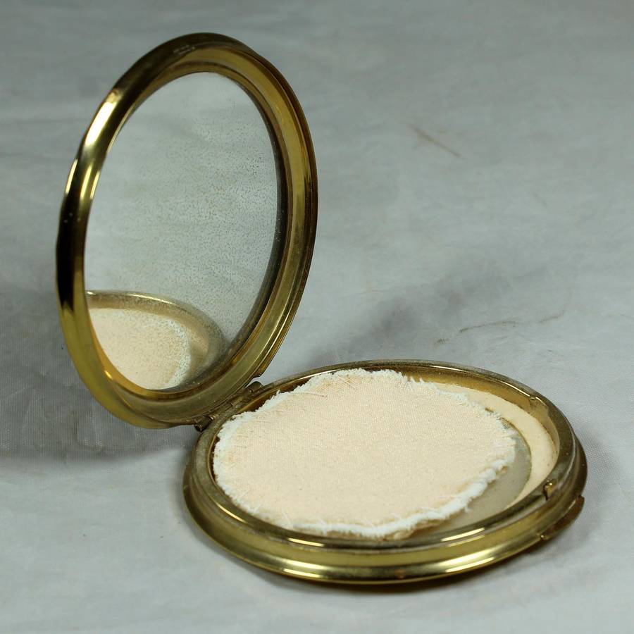 Gold tone powder compact