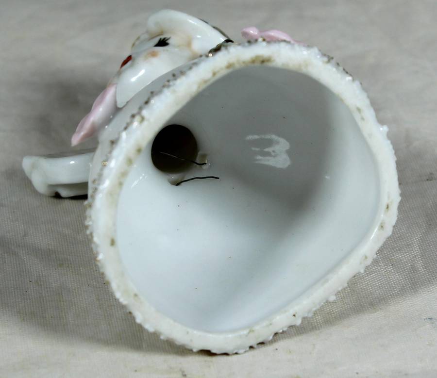 Little girl playing a harp bell