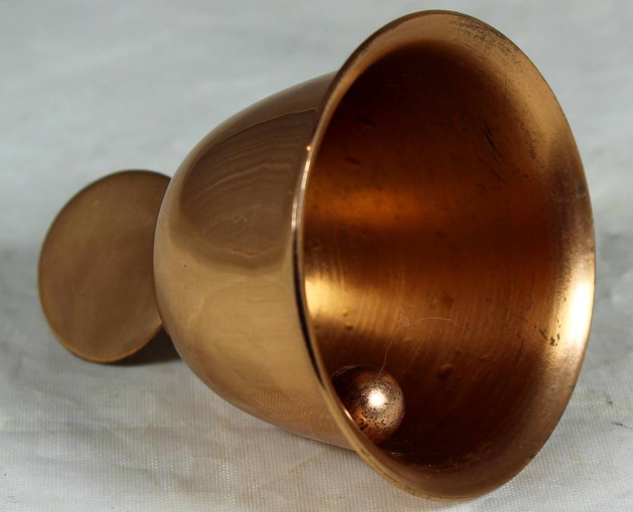 Souvenir copper bell with coin depicting flowers