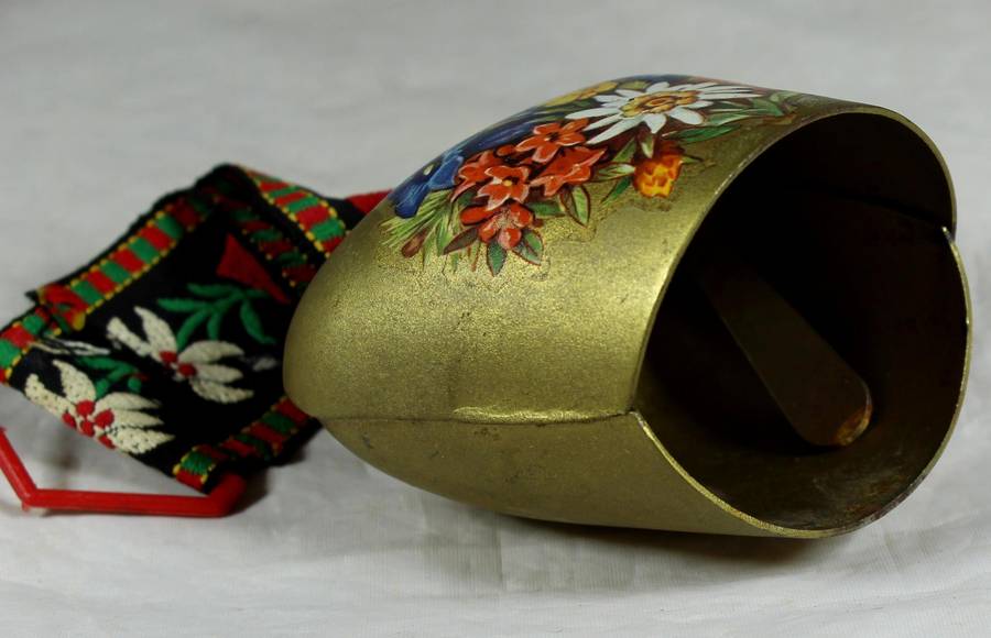 Cow bell with decorative strap