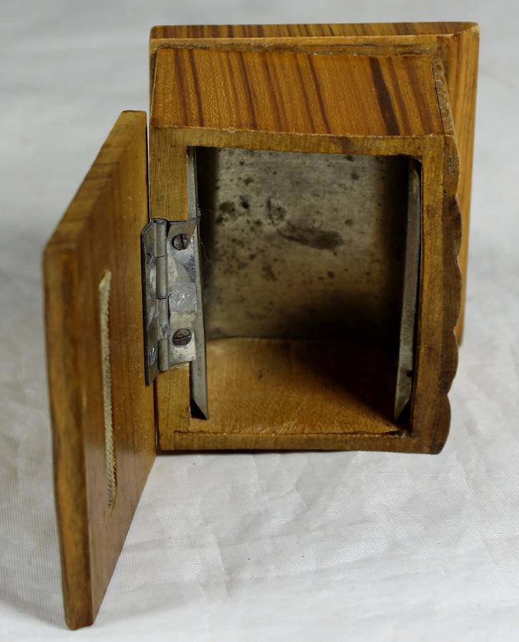 Small wooden box with carved books in front