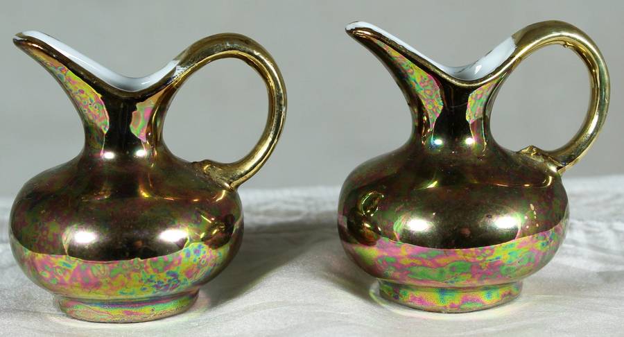 Miniature pair of golden covered pitchers