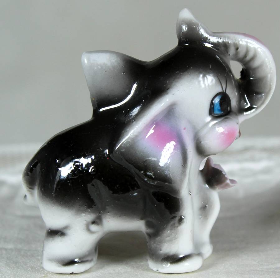 Miniature elephant with a flower