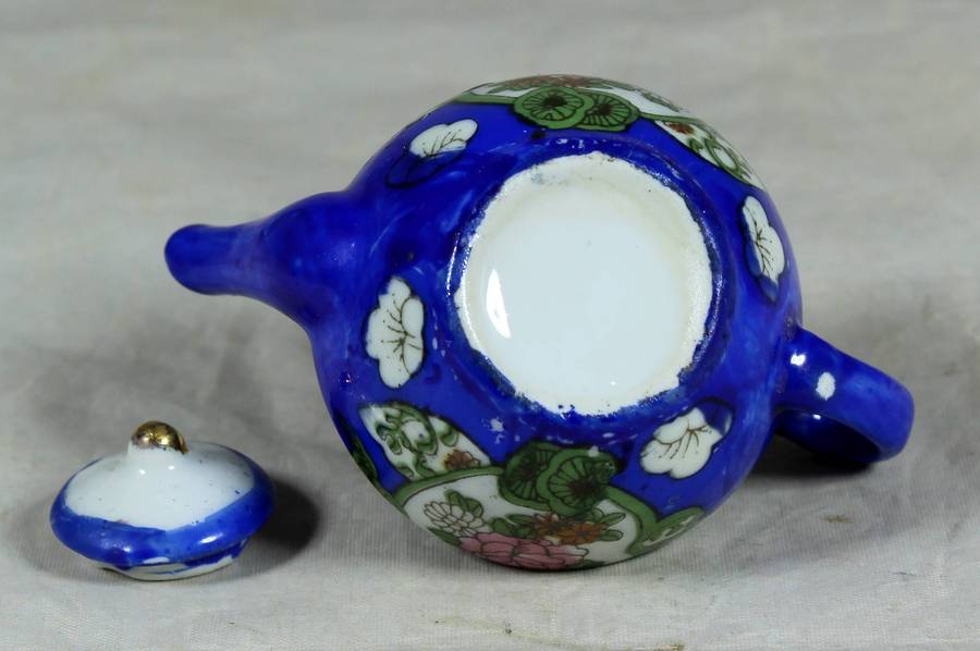 Miniature blue kettle with flowers