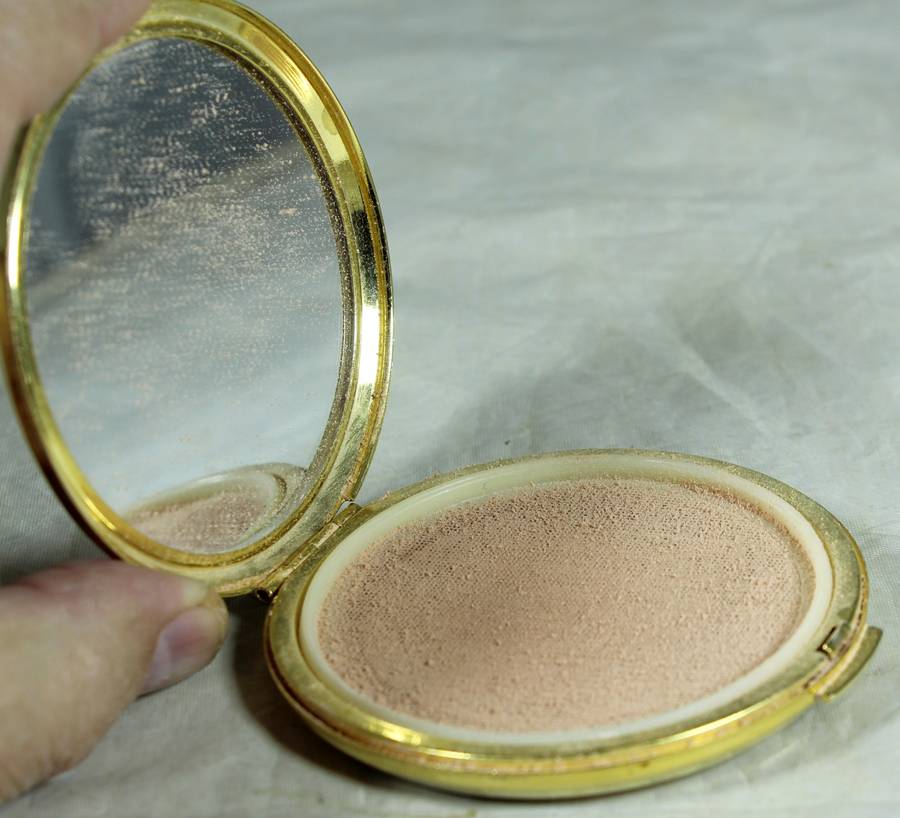 Golden powder compact with red rose