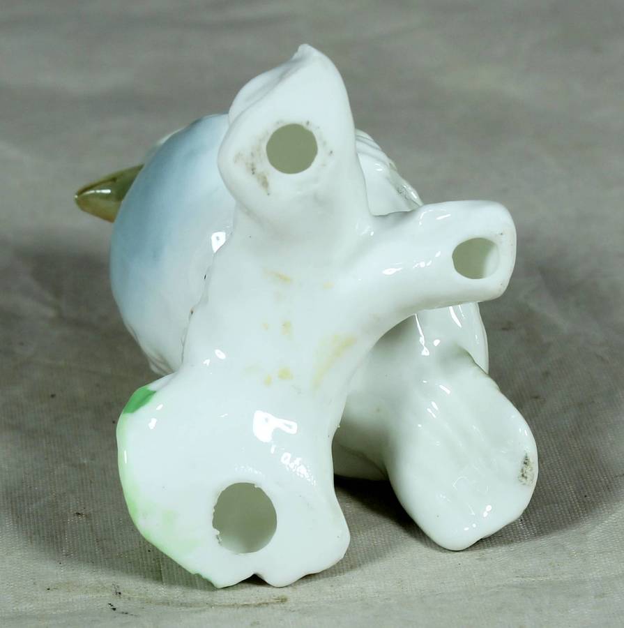 Small glazed bird on a branch