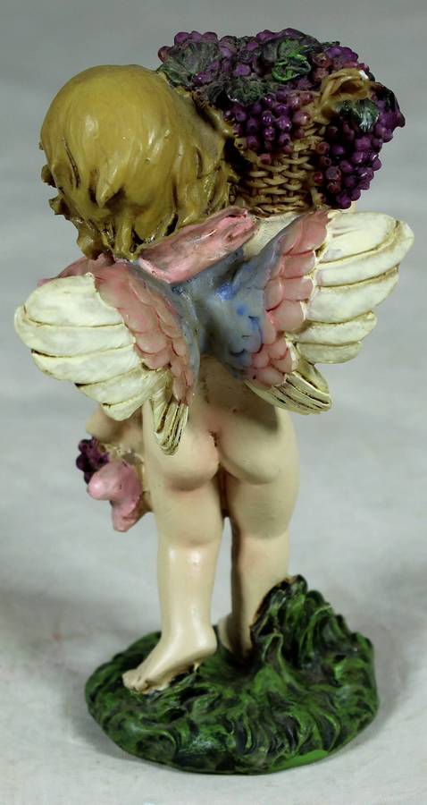 Fairy carrying a basket of grapes