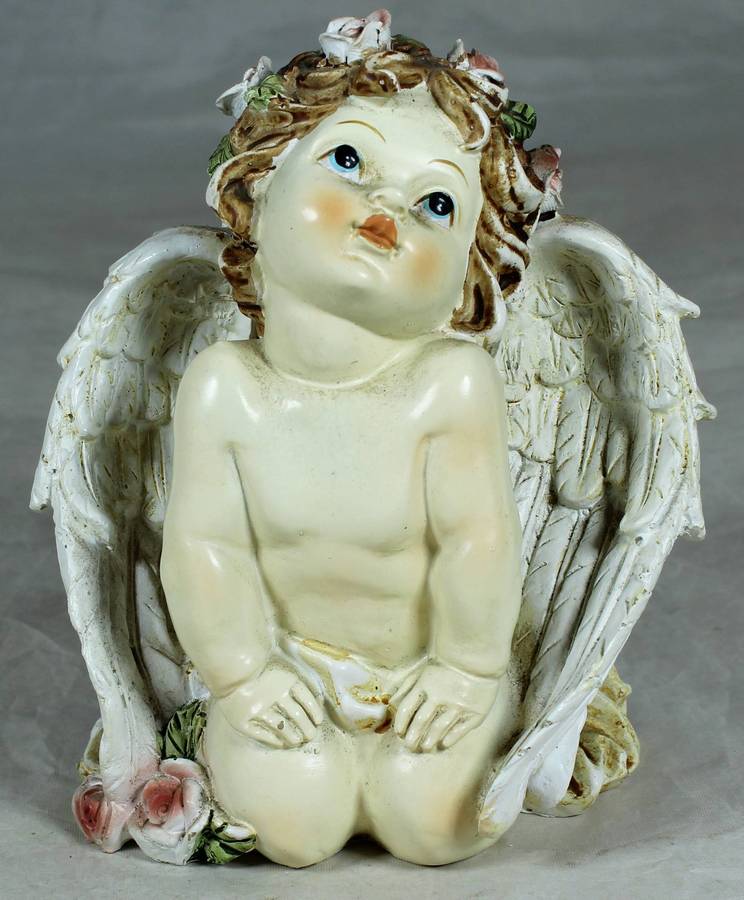 Kneeling baby angel with flowers in the hair