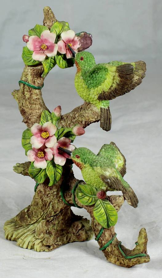 Molded bird on a tree, sucking nectar