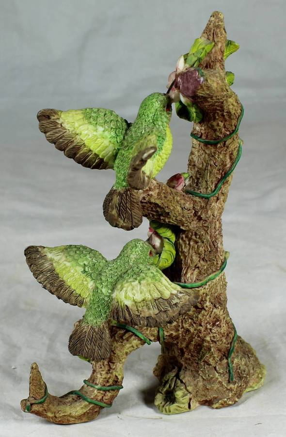 Molded bird on a tree, sucking nectar