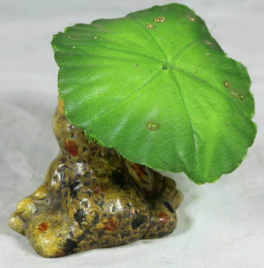 Ceramic frog holding a leaf umbrella