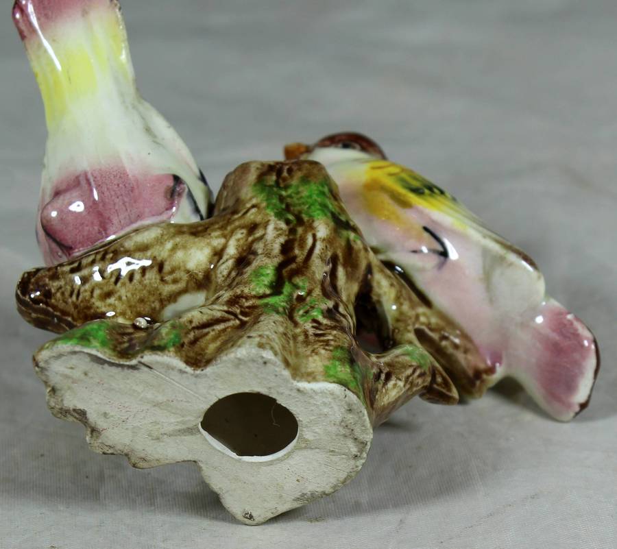 Pair of ceramic birds on a tree log