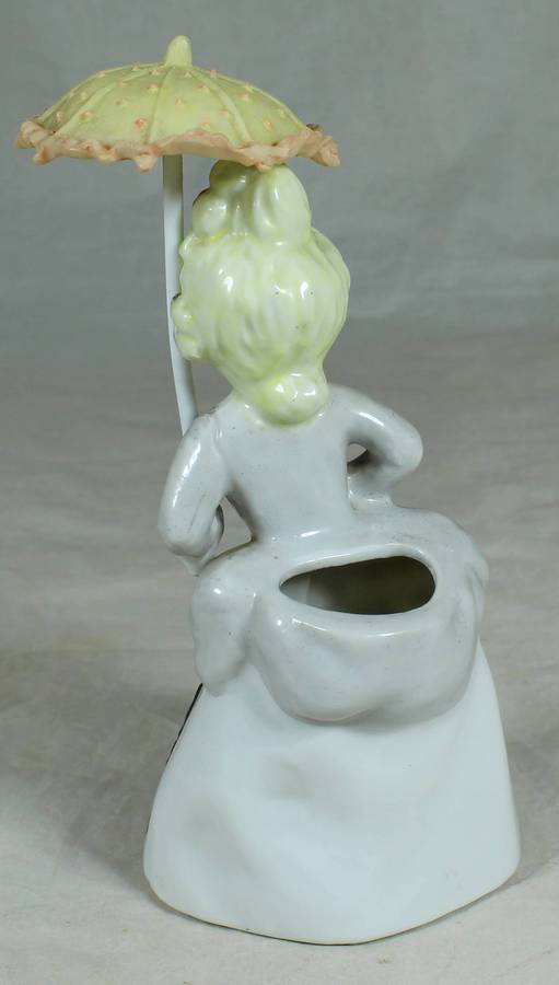 Ceramic girl in traditional dress with parasol