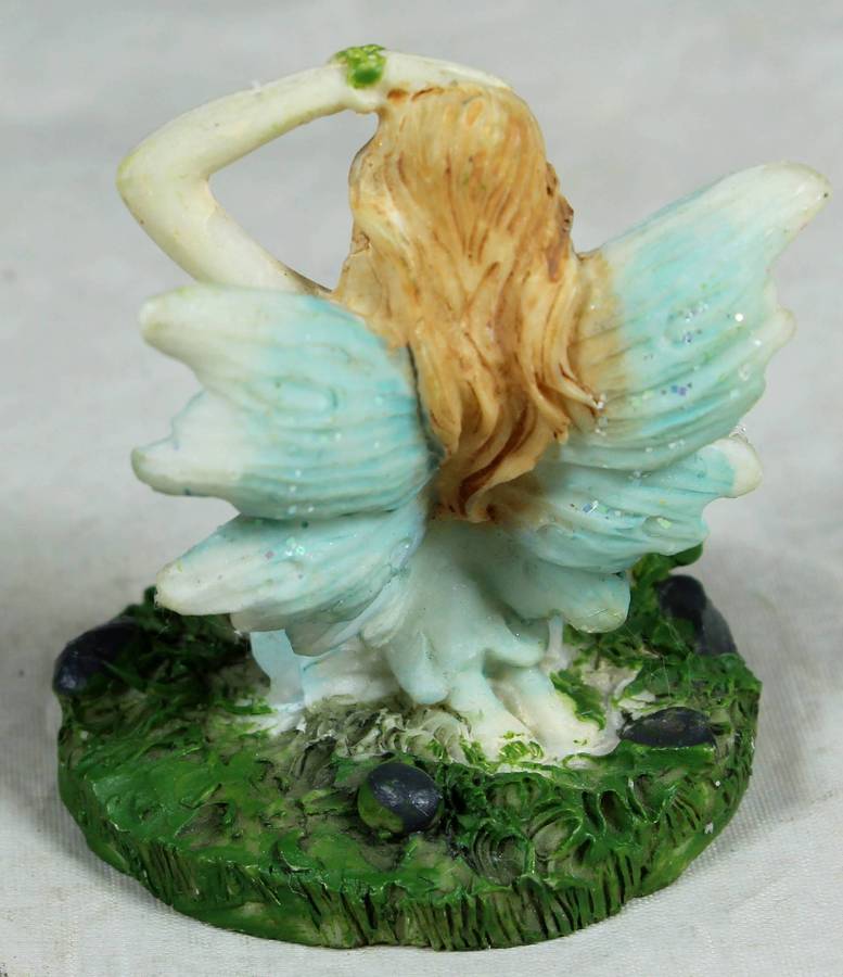 Molded figurine - Angel seated amongst the flowers