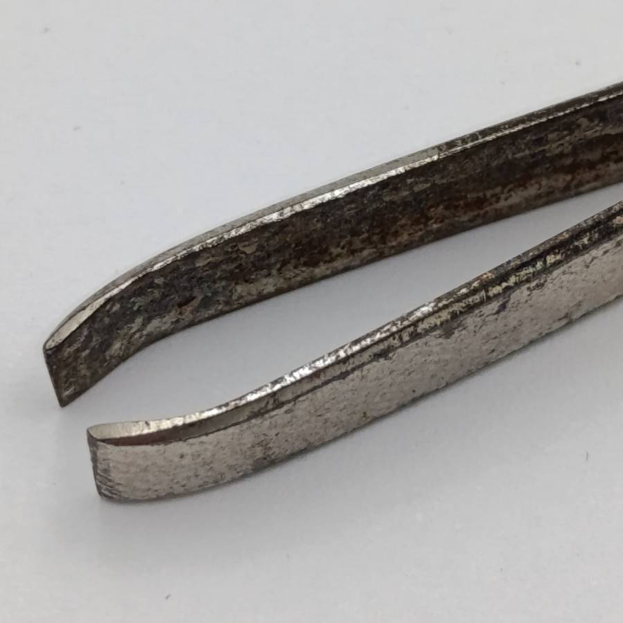 Antique tweezers with hallmarked sterling silver handle