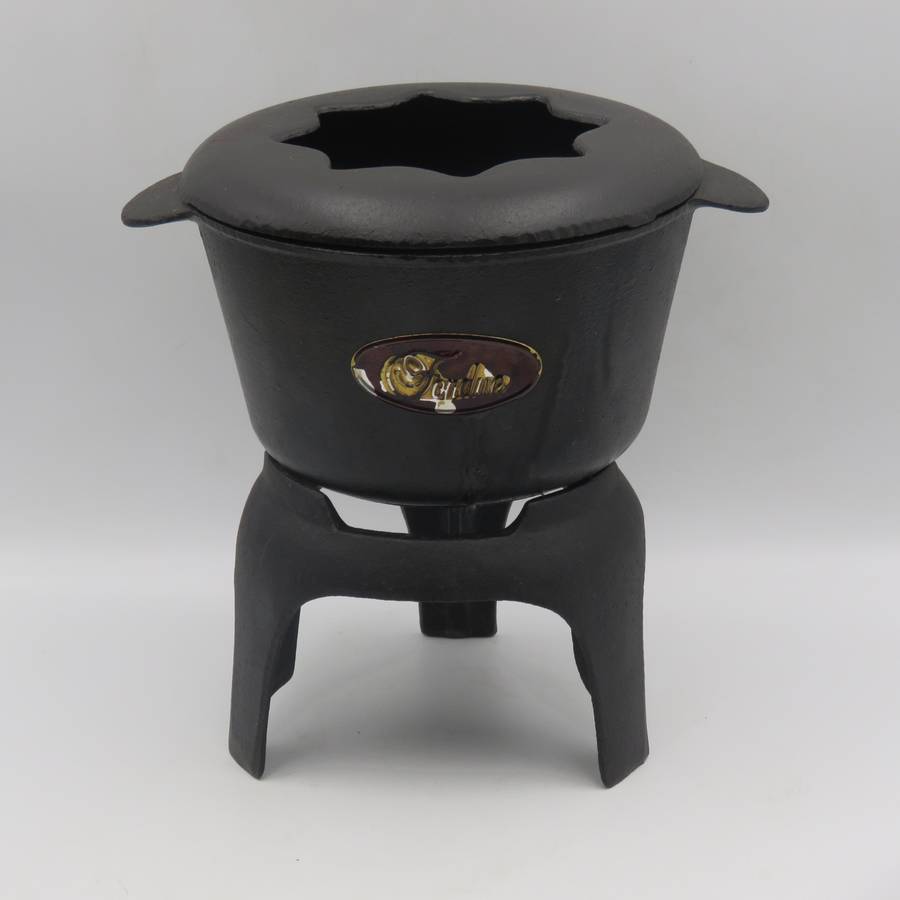 Vintage cast-iron fondue set with 8 forks