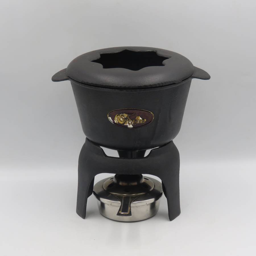 Vintage cast-iron fondue set with 8 forks