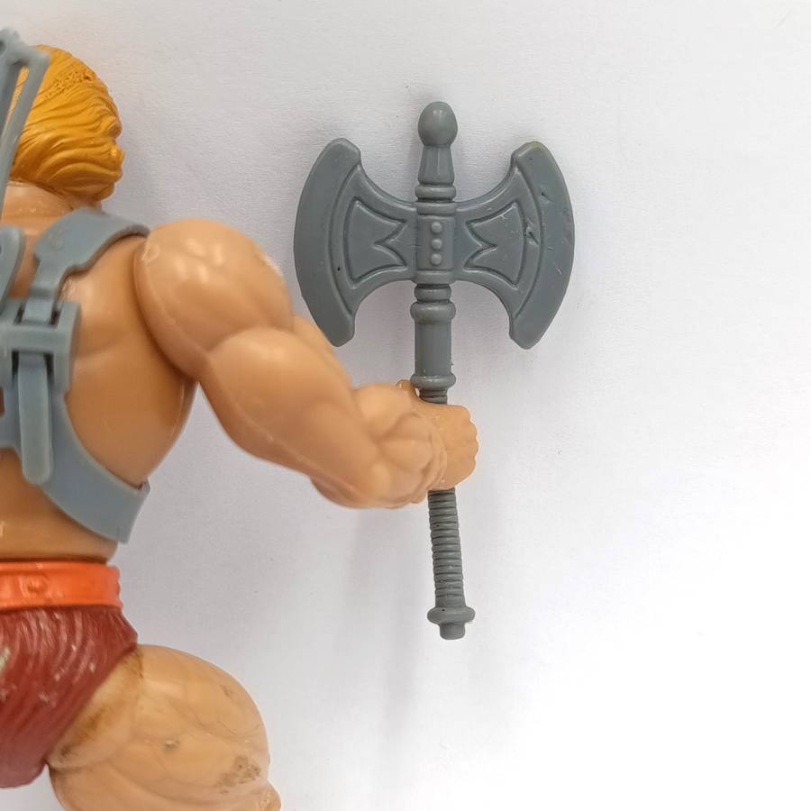 Vintage Masters of the Universe He-Man figurine with weapons and accessories