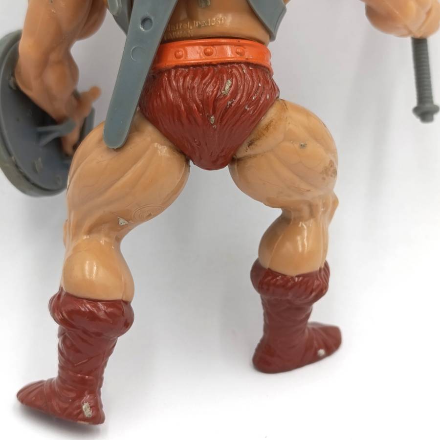 Vintage Masters of the Universe He-Man figurine with weapons and accessories