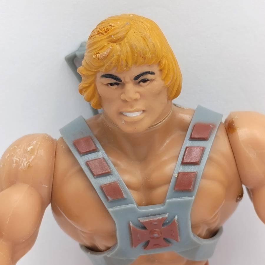 Vintage Masters of the Universe He-Man figurine with weapons and accessories
