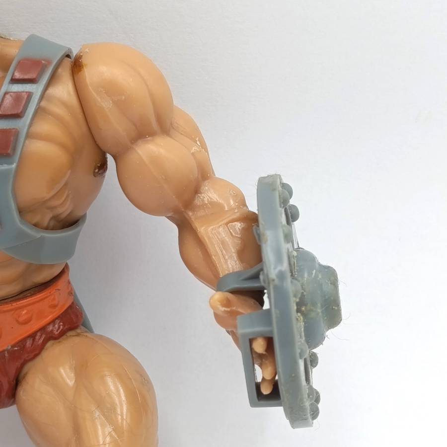 Vintage Masters of the Universe He-Man figurine with weapons and accessories