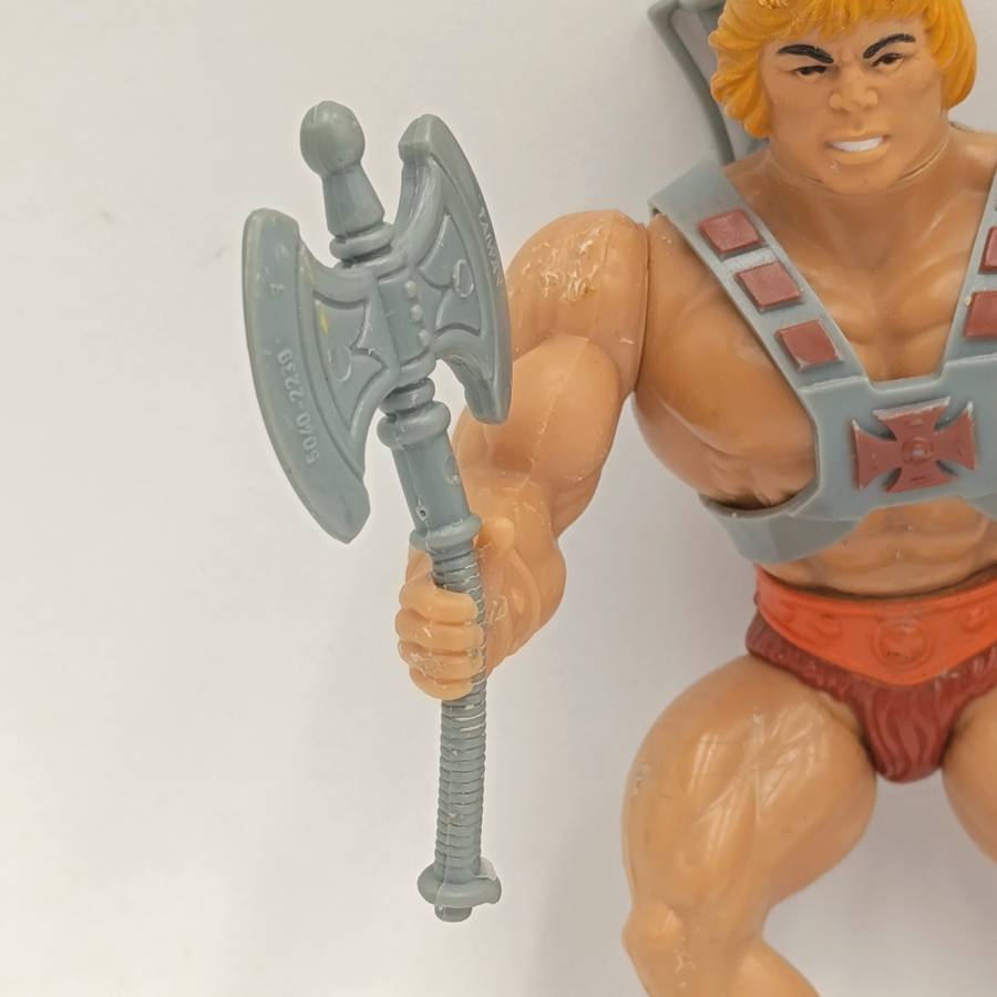 Vintage Masters of the Universe He-Man figurine with weapons and accessories