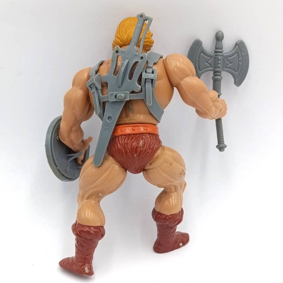 Vintage Masters of the Universe He-Man figurine with weapons and accessories