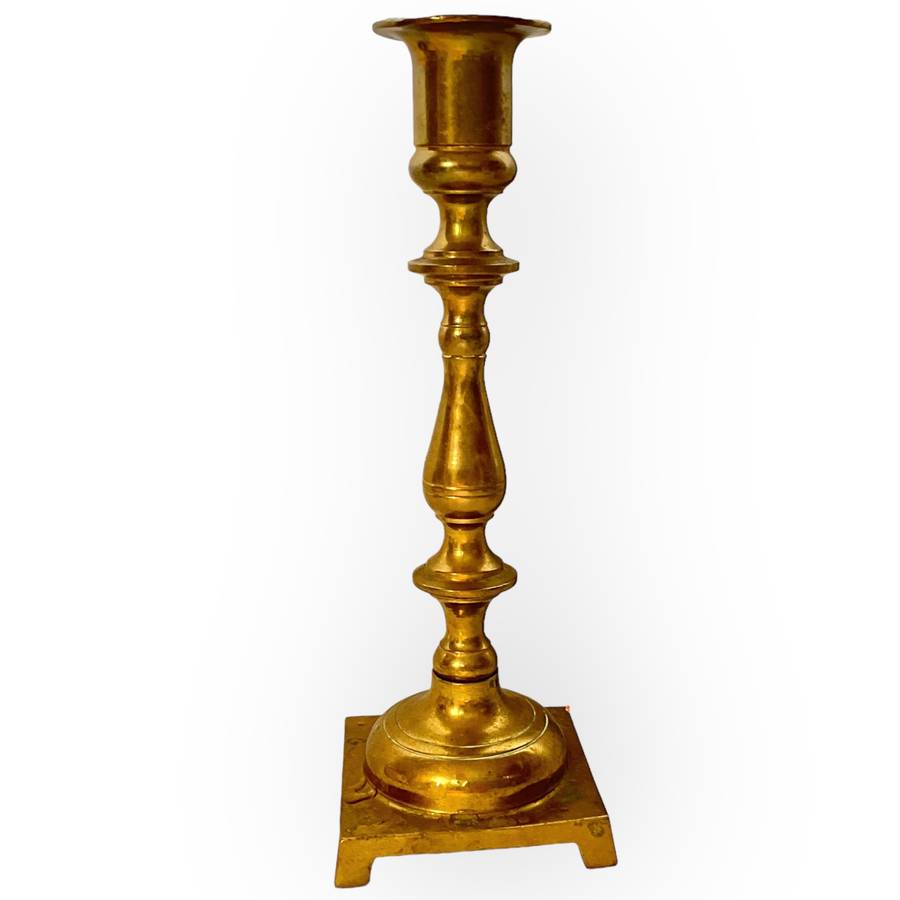 Three different styles of lighting- brass candlestick, Danish candleholder, modern floral tea light