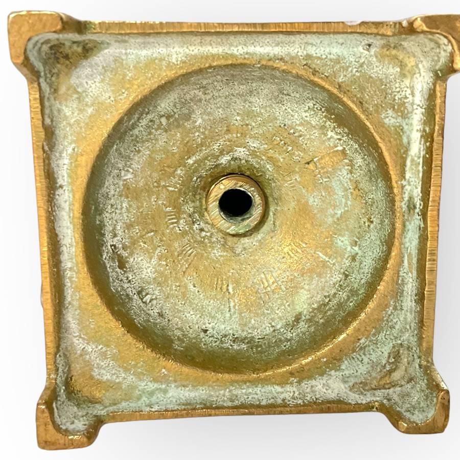 Three different styles of lighting- brass candlestick, Danish candleholder, modern floral tea light