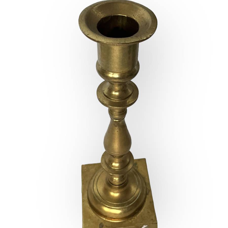 Three different styles of lighting- brass candlestick, Danish candleholder, modern floral tea light