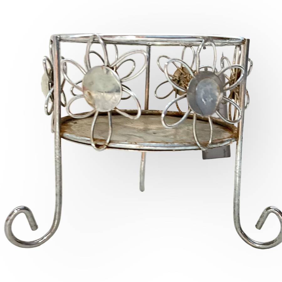 Three different styles of lighting- brass candlestick, Danish candleholder, modern floral tea light