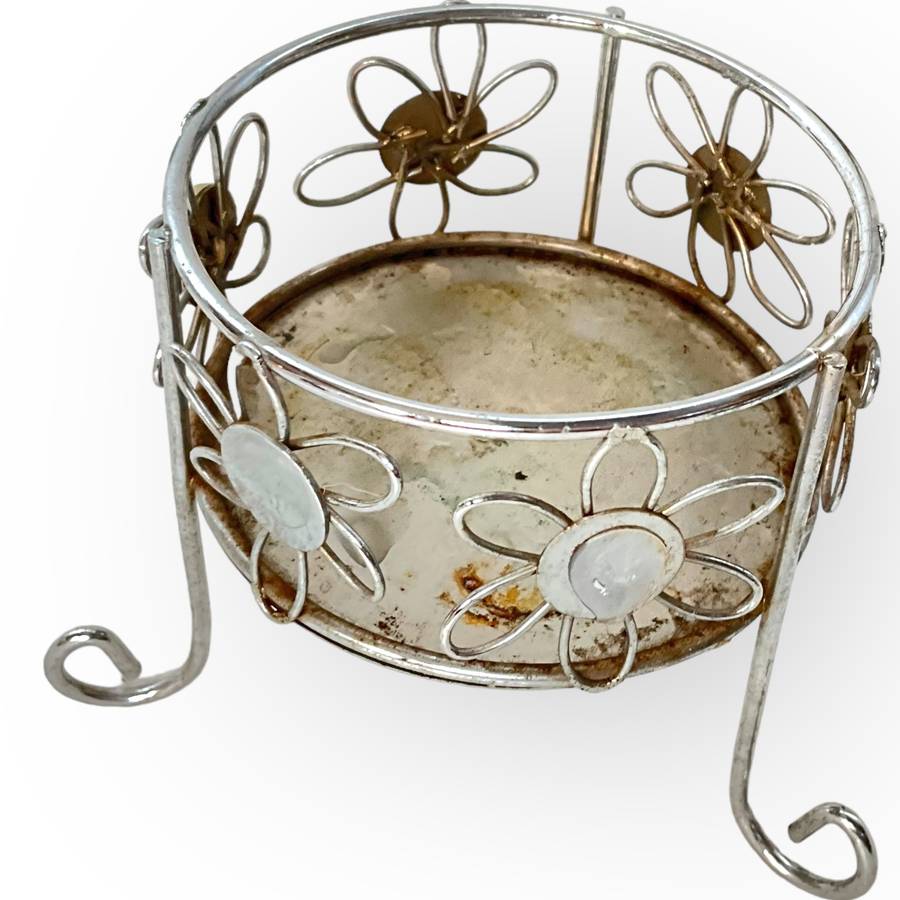 Three different styles of lighting- brass candlestick, Danish candleholder, modern floral tea light