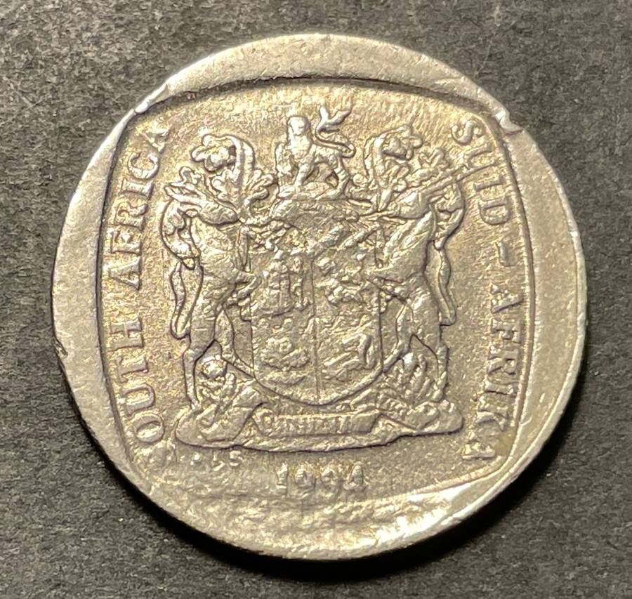 Nice 1994 error RSA 1 Rand coin with a large cud error (Broken die)